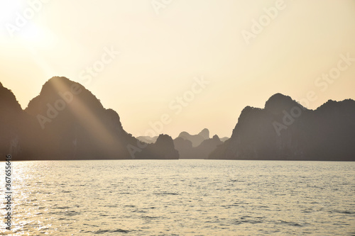 Halong Bay  UNESCO World Heritage  during a cloudless sunset with outlines of the beautiful karst landscape  Vietnam