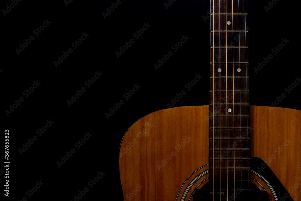 Close up detail of orange acoustic guitar