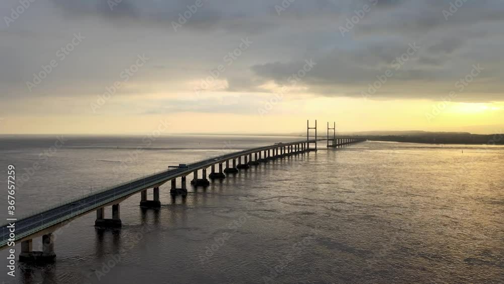 The Long Severn Bridge Spanning Across The Wide River In England On A Sunset View - MavicAir drone shot The Long Severn Bridge Spanning Across The Wide River In England On A Sunset View - MavicAir drone shot