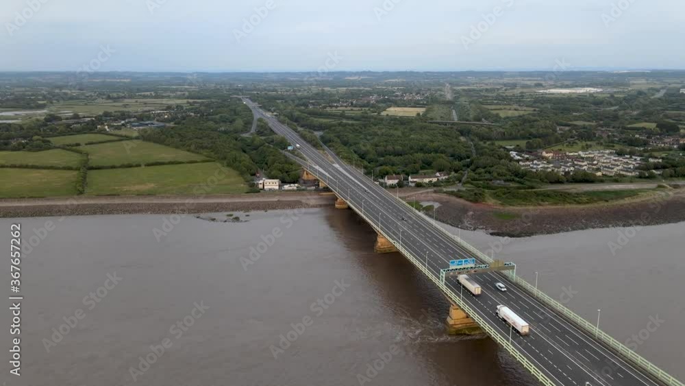 Vehicles Travelling On The Famous Severn Bridge Crossing Over Severn Estuary Between England And Wales At Daytime - MavicAir drone shot Vehicles Travelling On The Famous Severn Bridge Crossing Over Severn Estuary Between England And Wales At Daytime - MavicAir drone shot
