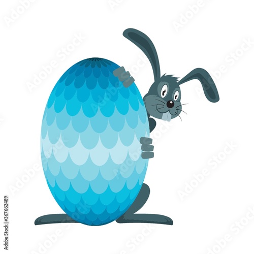 bunny hiding behind an easter egg