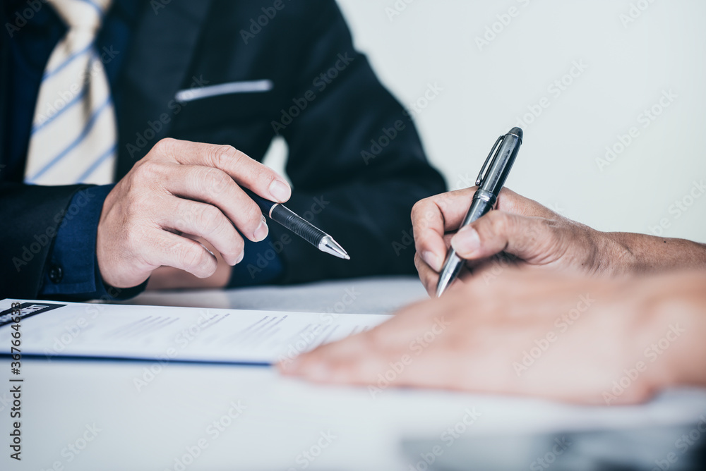 Close up human hands pointing at business document at meeting in the office.
