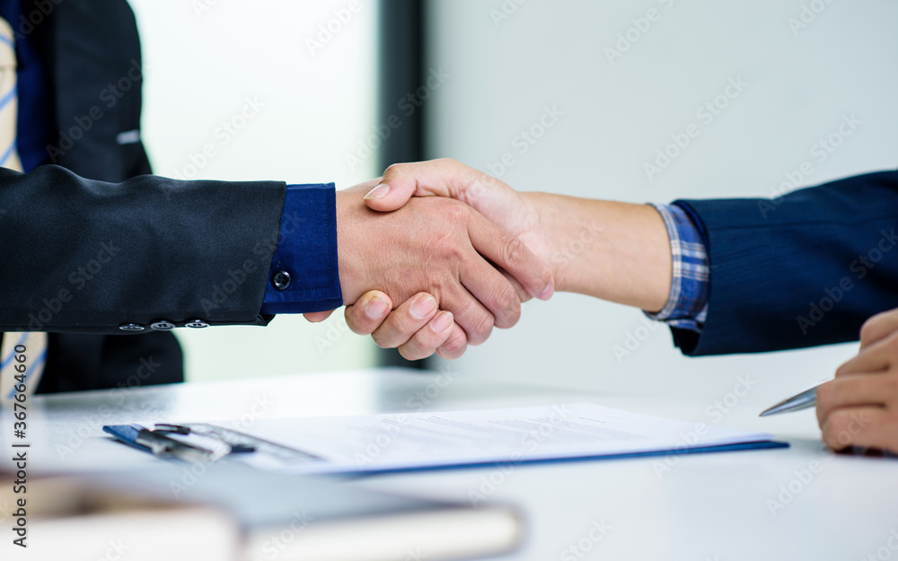 Shaking hands business people in office, business communication and marketing concept.