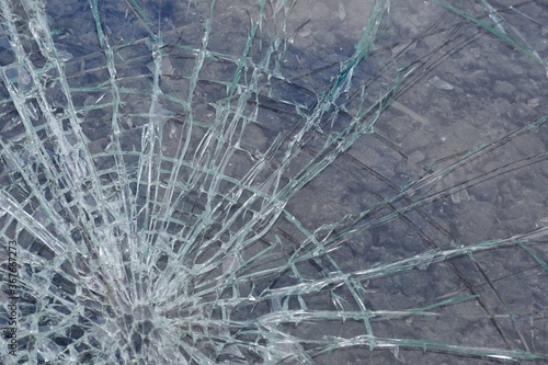 Broken glass with cracks and splinters  background  texture.