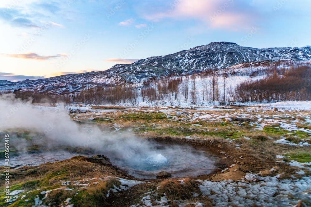The geysir in golden circle, Iceland, in winter time, at sunset.