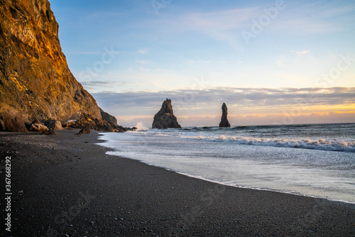 Reynisfjara, the black sand beach at vik, in Iceland, in winter time, at sunset.