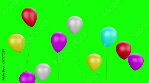 Colorful party balloons flying with green background photo