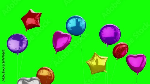 Shiny colorful party balloons flying with green background photo