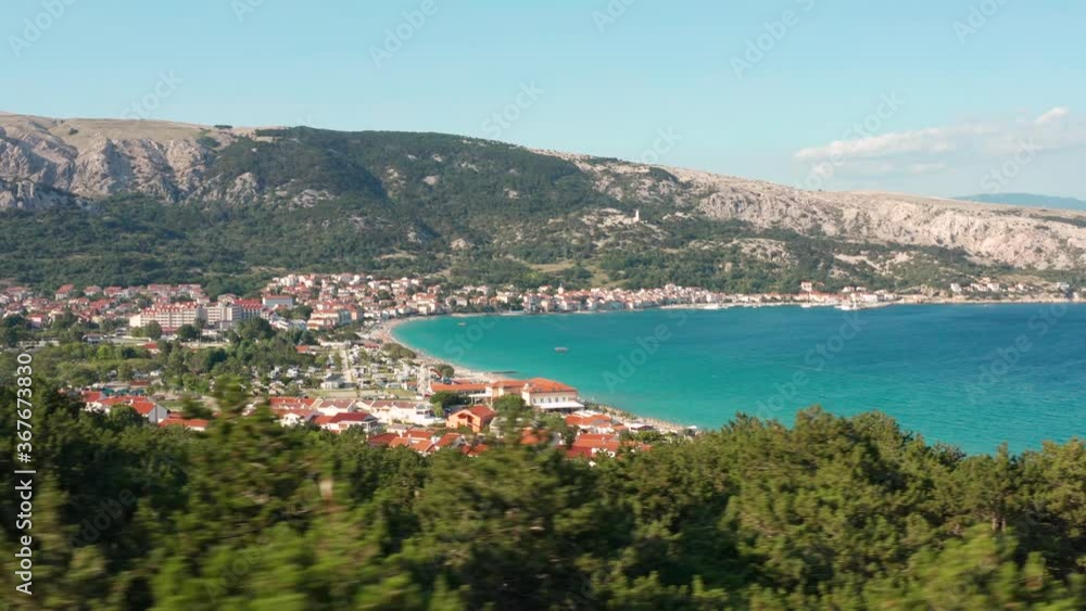 The Lush Green Forest By The Mountains And Revealing The Beautiful Ocean And Seaside Town Of Baska In Krk Island, Croatia. - aerial panning The Lush Green Forest By The Mountains And Revealing The Beautiful Ocean And Seaside Town Of Baska In Krk Island, Croatia. - aerial panning