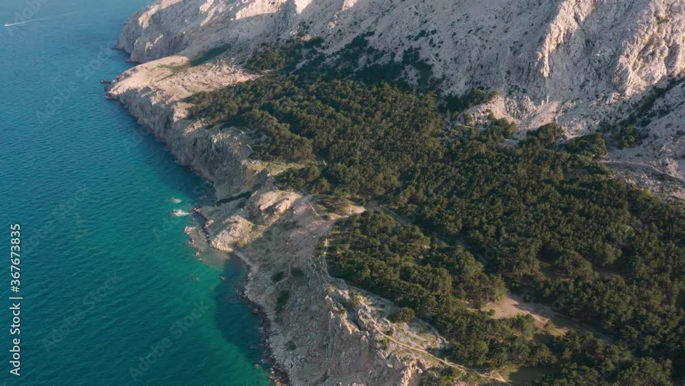 Majestic Landscape Of Rocky Coastal Cliffs By The Calm Blue Sea Near The Krk Island In Croatia. - aerial drone Majestic Landscape Of Rocky Coastal Cliffs By The Calm Blue Sea Near The Krk Island In Croatia. - aerial drone
