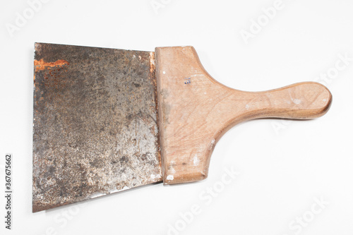 old painter's spatula with rust with wooden handle on white background photo