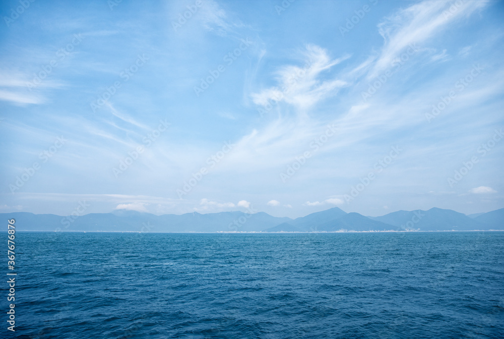 Creative layout made of horizon of the sea and soft wave with blue sky on background. Nature concept. Background concept. Close up with copy space.