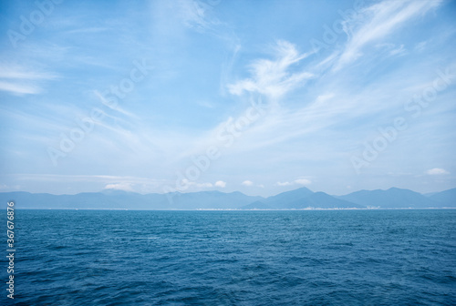 Creative layout made of horizon of the sea and soft wave with blue sky on background. Nature concept. Background concept. Close up with copy space.