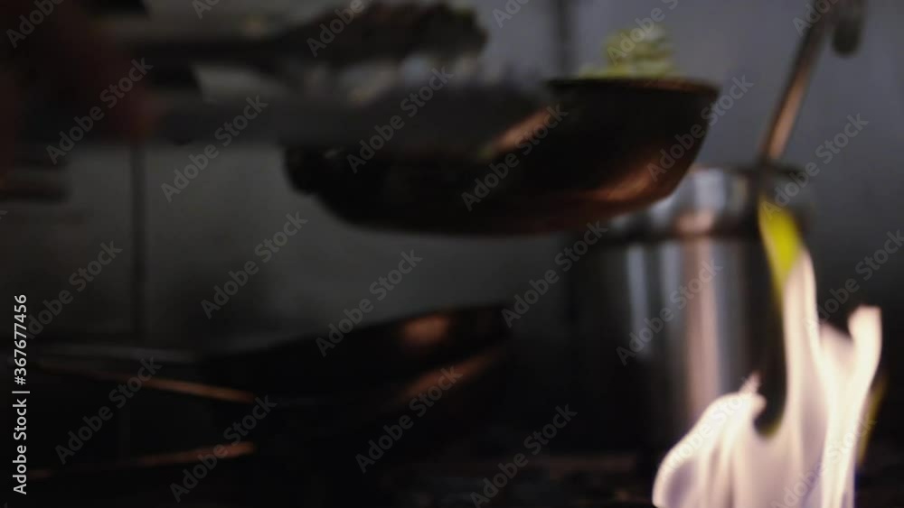 Chef flipping food in saucepan Chef flipping food in saucepan