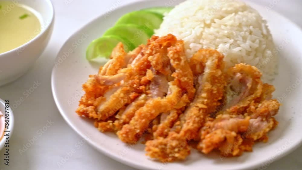 Hainanese chicken rice with fried chicken or rice steamed chicken soup with fried chicken - Asian food style Hainanese chicken rice with fried chicken or rice steamed chicken soup with fried chicken - Asian food style
