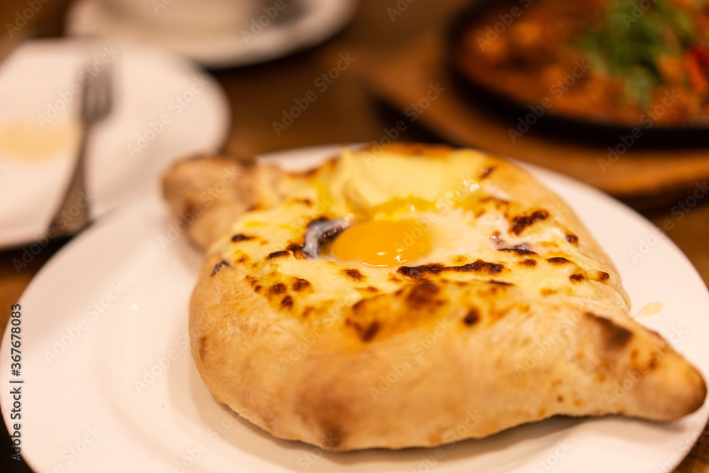 Khachapuri, roast bread with cheese and egg, a traditional georgian dish.