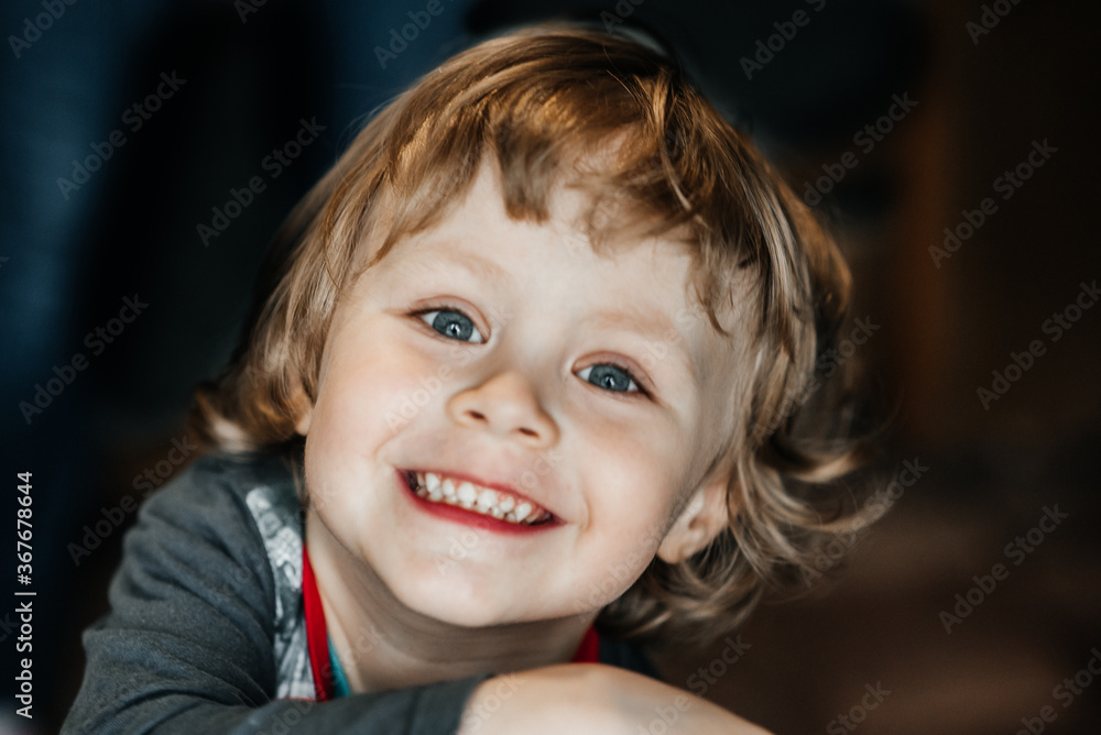 attractive boy of three years old smiling with teeth with looking at the camera, joy. happy childhood of child and son attractive boy of three years old smiling with teeth with looking at the camera, joy. happy childhood of child and son