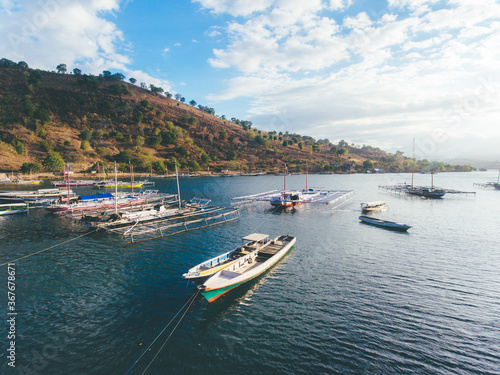 Aerial view of traditional fisherman boat anchored using a rope in Bima, Indonesia
