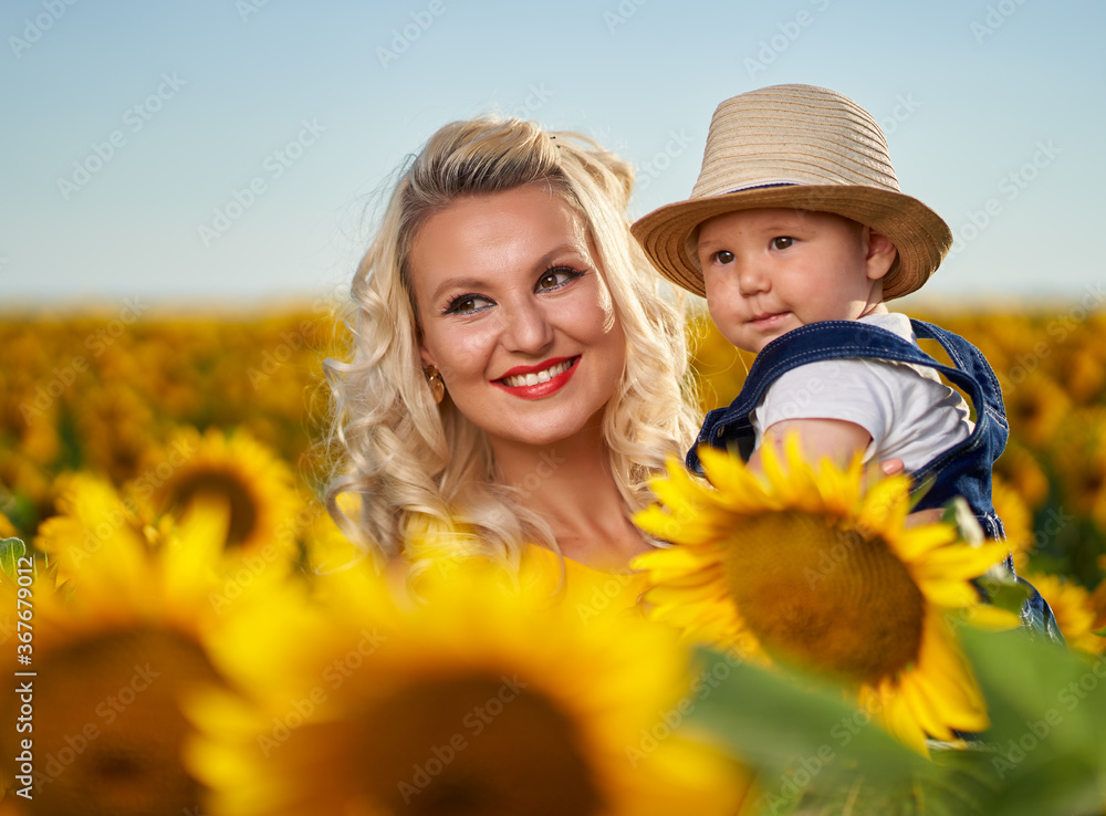 Mother and son in a sunflower field Mother and son in a sunflower field