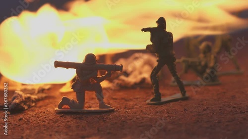 toy soldier in the fire. The model of the battle scene. The concept of the cruelty of war photo