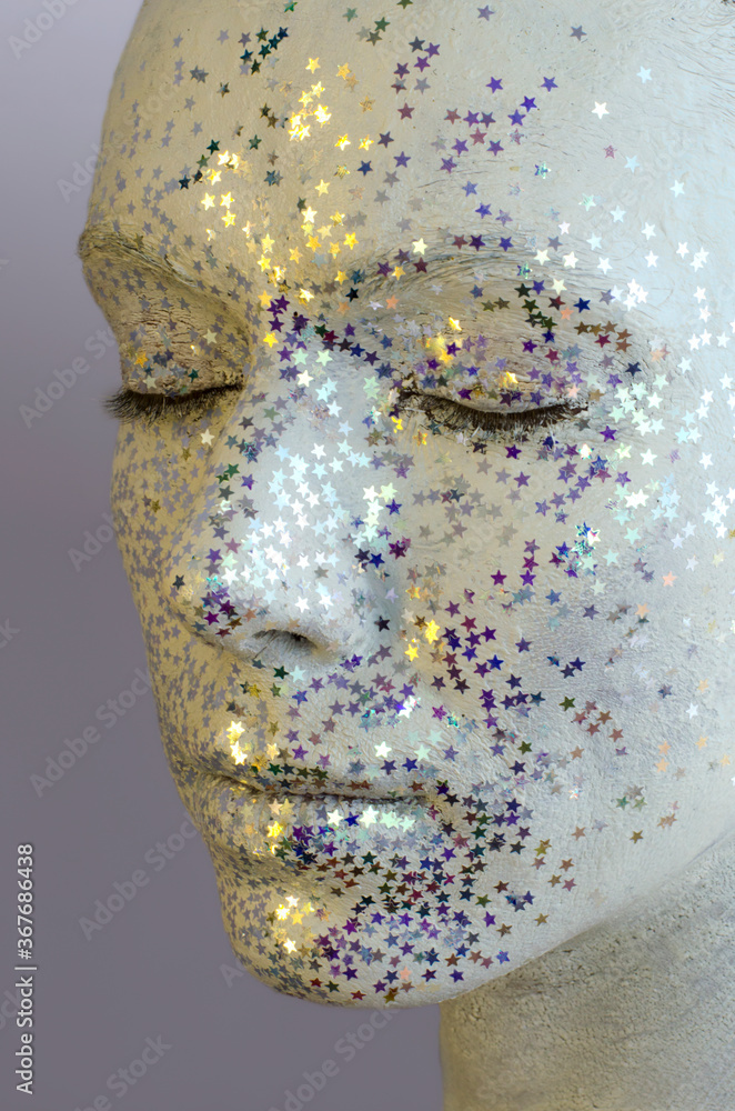 Obraz premium Close-up Portrait of Alternative Model with Creative Make-up. White Makeup, Decorative Stars and Glitter Sparkles all over Woman Face.