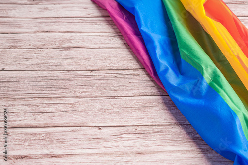 Close-up of LGBT flag on wooden table