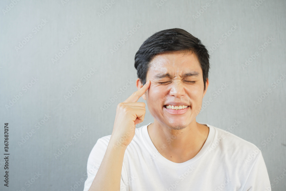 close up young man (30s) using finger to point on face to show wrinkle around eyes for anti-aging and beauty treatment concept close up young man (30s) using finger to point on face to show wrinkle around eyes for anti-aging and beauty treatment concept