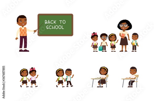 African schoolchildren and teachers. Cheerful classmates standing near blackboard. Children go to school, sit at  schooldesk. Greeting on school chalkboard. The concept of back to school. 