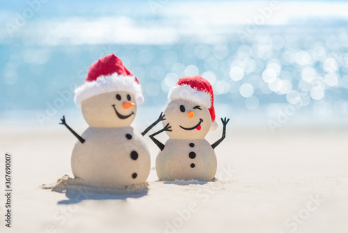 Photos Two Sandy Christmas Snowmen are celebrating Christmas on a beautiful beach with