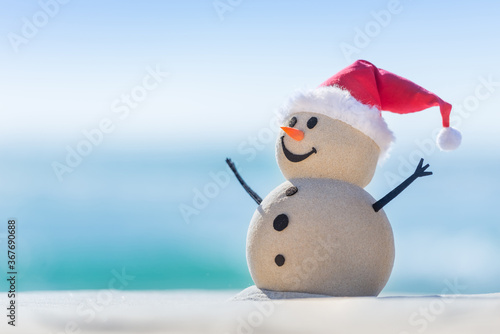 Sandy Christmas Snowman is celebrating Christmas on a beautiful beach