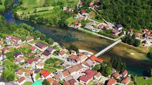 Picturesque town of Kulen Vakuf connected by bridge on river Una photo