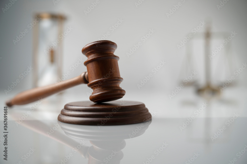Law and justice concept. Scale, gavel and hourglass on off-white background. Law and justice concept. Scale, gavel and hourglass on off-white background.