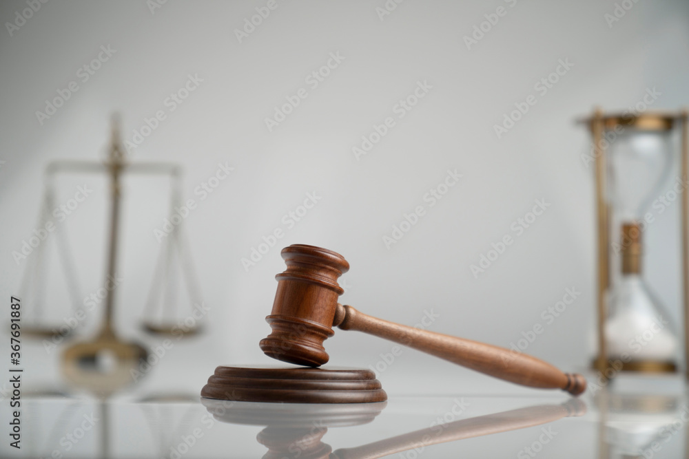 Law and justice concept. Scale, gavel and hourglass on off-white background. Law and justice concept. Scale, gavel and hourglass on off-white background.