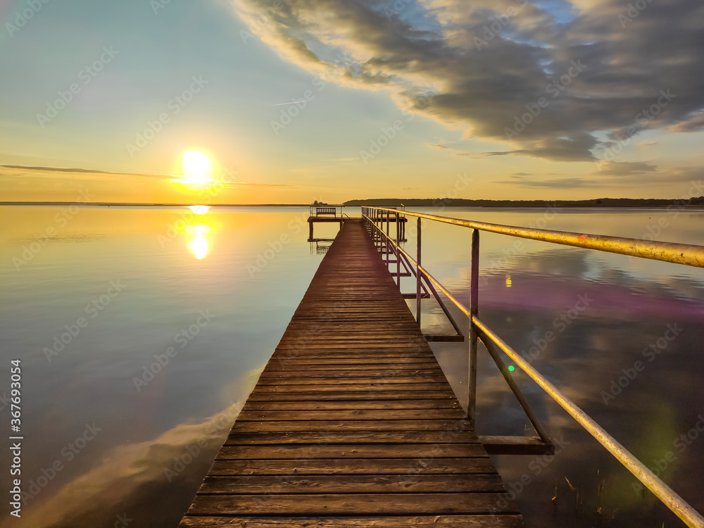 beautiful boardwalk during sunrise at lake Müritz