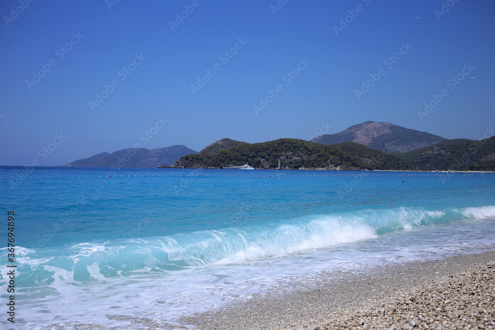 The blue stormy sea off the coast of Oludeniz in Turkey is one of the most beautiful and popular tourist destinations in Turkey.