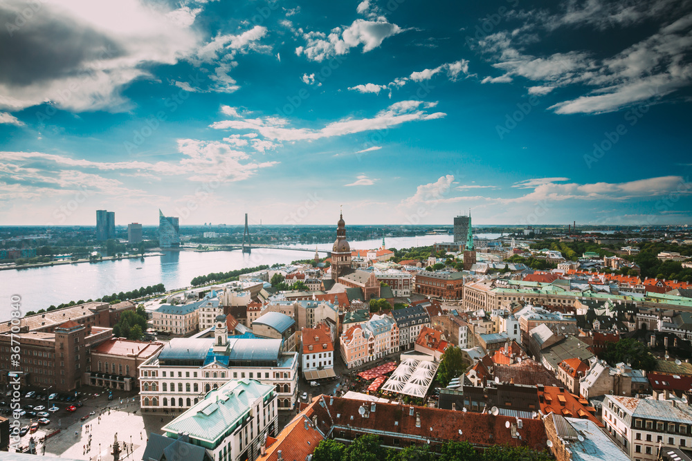 Riga, Latvia. Riga Cityscape Slyline In Sunny Summer Day. Famous Landmarks - Riga Dome Cathedral And St. James's Cathedral, or the Cathedral Basilica of St. James