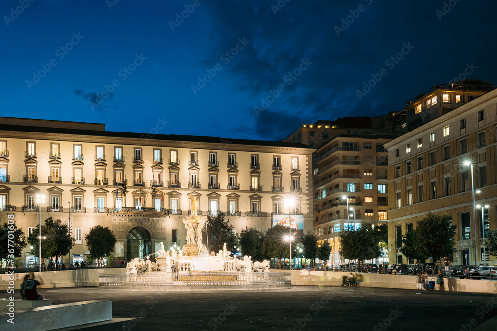 Naples, Italy. Fountain Of Neptune On Piazza Municipio In Evening Or Night Illuminations