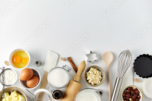 food, culinary and recipe concept - cooking ingredients and kitchen tools for baking on table
