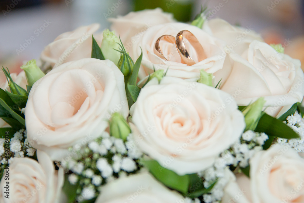bright wedding bouquet of summer flowers  with wedding rings