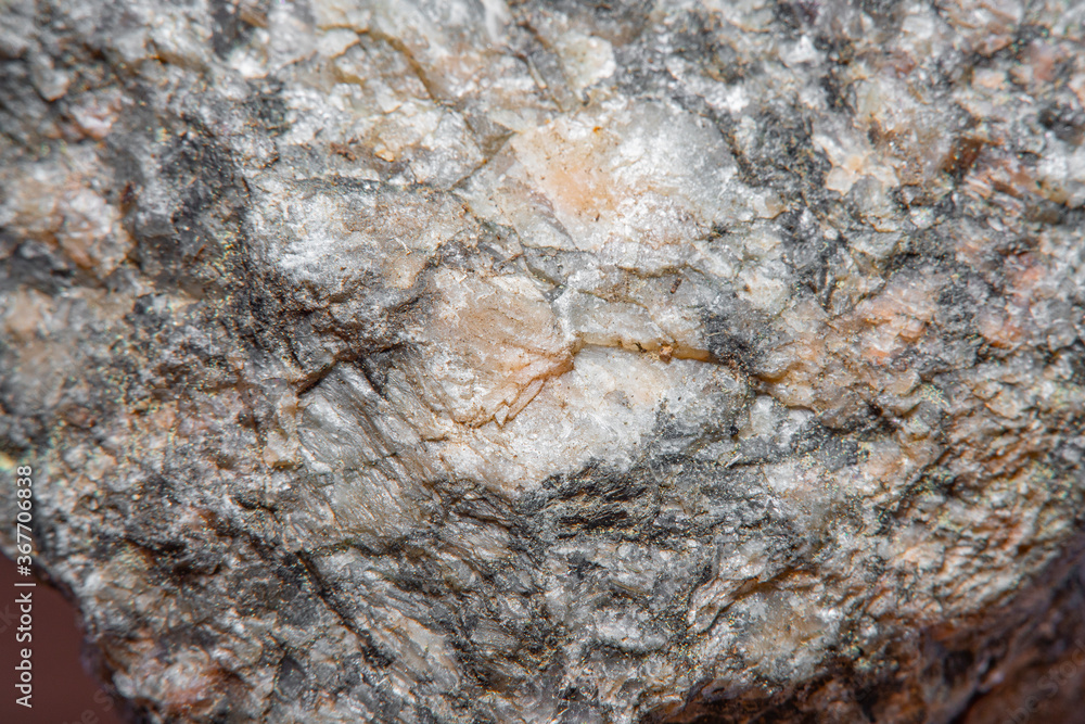 Photograph of a granite surface in soft focus at high magnification. Fine texture of natural mineral of pink color with blurred background. Stone with soft stains of color. Photograph of a granite surface in soft focus at high magnification. Fine texture of natural mineral of pink color with blurred background. Stone with soft stains of color.