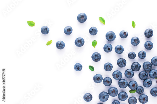 Blueberries with leaves on a white isolated background, fruit scatter.