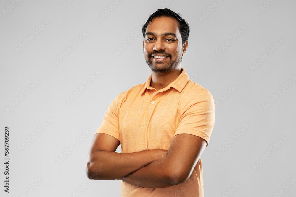 people and furniture concept - portrait of happy smiling young indian man with crossed arms over grey background - obrazy, fototapety, plakaty 