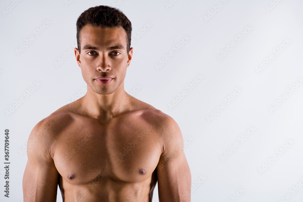 Close-up portrait of his he nice attractive content serious strong tanned guy working out crossfit exercise health care body care healthy life isolated over light white pastel color background Close-up portrait of his he nice attractive content serious strong tanned guy working out crossfit exercise health care body care healthy life isolated over light white pastel color background