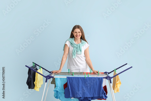 Woman hanging clean clothes...