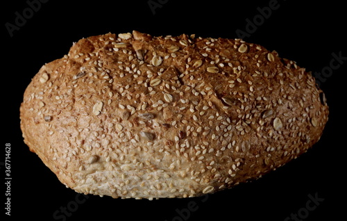 Integral rye bread loaf with sesame seeds isolated on black background with clipping path