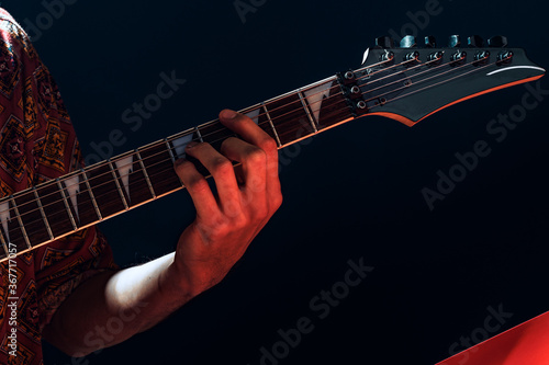 Close up photo of male hands playing guitar