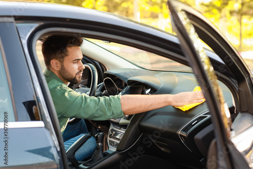 Man cleaning his car inside