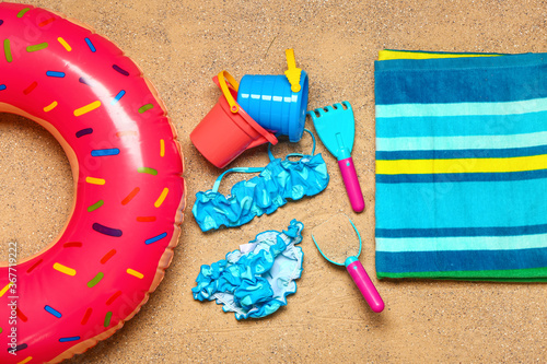 Set of beach accessories for children on sand, top view