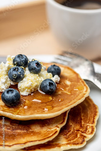 
Sunday morning. Delicious breakfast on a wooden tray in the hands of a man.