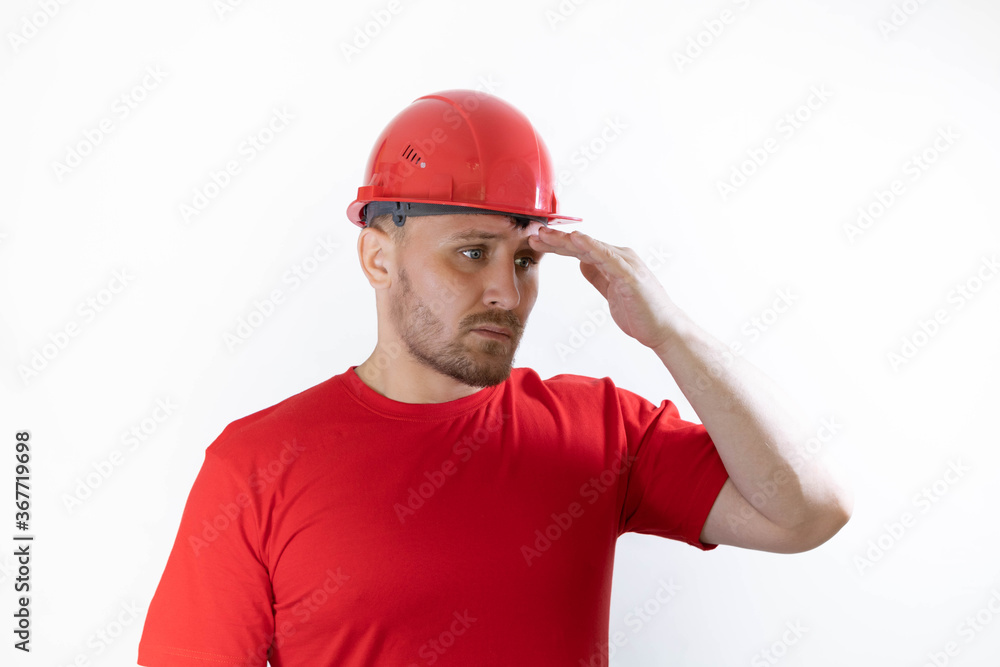 Construction worker in red construction helmet. Builder with a guilty face. Construction worker in red construction helmet. Builder with a guilty face.